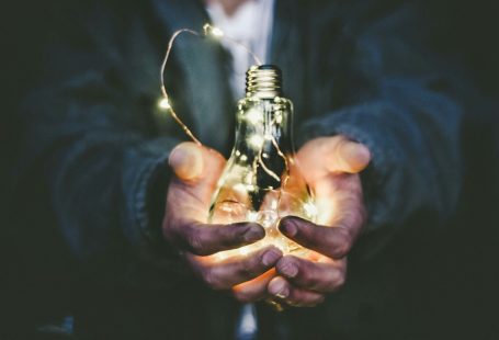 man holding incandescent bulb